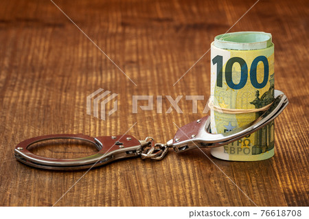 Money and handcuffs Money and handcuffs 76618708