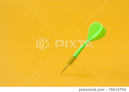 Green dart arrow on the yellow background Green dart arrow on the yellow background 76618709