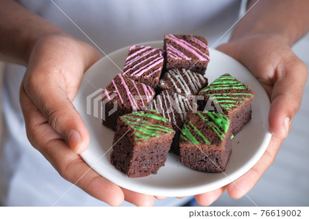 slice of homemade brownie on plate on table  76619002