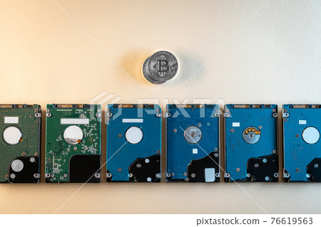 top view of bitcoin cryptocurrency coin with hard disk drive hdd, flat lay top view of bitcoin cryptocurrency coin with hard disk drive hdd, flat lay 76619563