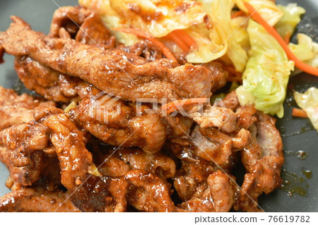 grilled slice pork with Sichuan pepper sauce and cabbage on plate 76619782