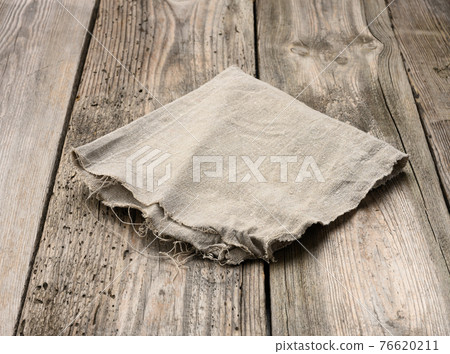 gray linen kitchen towel on a table made of old wooden boards 76620211