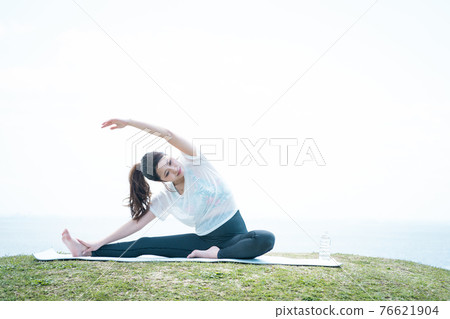 Young woman stretching outside Young woman stretching outside 76621904