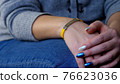 Female hand with vaccined bracelet or label after injection 76623036