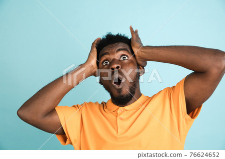 African man's portrait isolated over blue studio background with copyspace 76624652