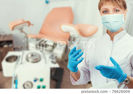 Female gynecologist in protective mask Female gynecologist in protective mask 76626009