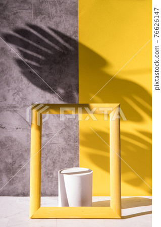 Catwalk, a cosmetic showcase with a yellow frame and tropical leaf shadows on a gray-yellow background. Trending colors 2121 Catwalk, a cosmetic showcase with a yellow frame and tropical leaf shadows on a gray-yellow background. Trending colors 2121 76626147