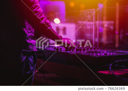 professional stage sound mixer closeup at sound engineer hand using audio mix slider working during concert performance professional stage sound mixer closeup at sound engineer hand using audio mix slider working during concert performance 76626369