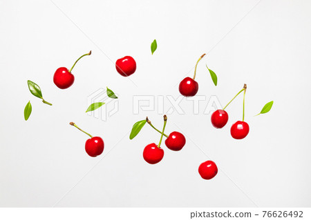 Ripe cherry berry with green leaves levitating on white background. Berry summer background. Flat lay, top view, copy space 76626492