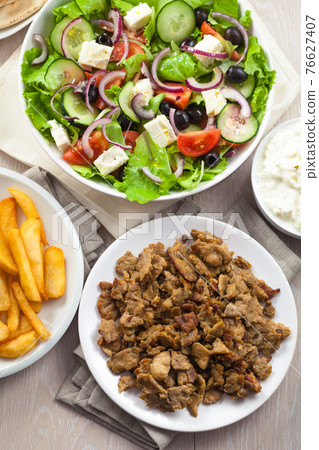 Greek Salad with Gyros and Fries. High quality photo. Greek Salad with Gyros and Fries. High quality photo. 76627407