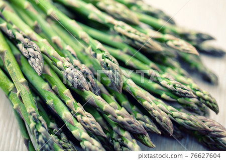 Wild Asparagus on a table. High quality photo. 76627604