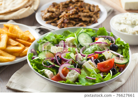 Greek Salad with Gyros and Fries. High quality photo. Greek Salad with Gyros and Fries. High quality photo. 76627661