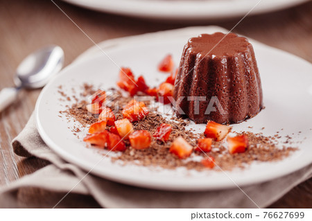 Chocolate pudding with fresh strawberries on a plate. Chocolate pudding with fresh strawberries on a plate. 76627699