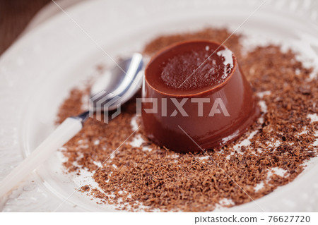 Chocolate pudding with fresh strawberries on a plate. Chocolate pudding with fresh strawberries on a plate. 76627720