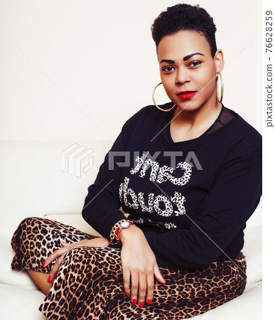pretty stylish african american big mama woman well dressed. swag relax at home, leopard print on clothers. fashion look sunglasses 76628259