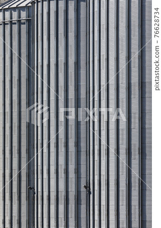 The corrugated steel sides of a storage silo at a flour mill The corrugated steel sides of a storage silo at a flour mill 76628734