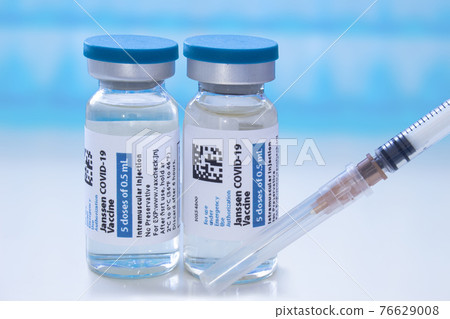 Calgary, Alberta, Canada. April 8, 2021. A couple of Janssen Johnson & Johnson dosis of Covid-19 vaccines on vial bottles and an injection syringe. Calgary, Alberta, Canada. April 8, 2021. A couple of Janssen Johnson & Johnson dosis of Covid-19 vaccines on vial bottles and an injection syringe. 76629008
