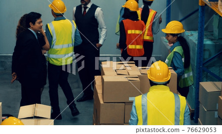 Many people , workers and manger work in warehouse or storehouse Many people , workers and manger work in warehouse or storehouse 76629053