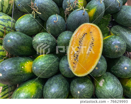 Full frame photo of a pile of yellow watermelon for backgrounds concept Full frame photo of a pile of yellow watermelon for backgrounds concept 76629993