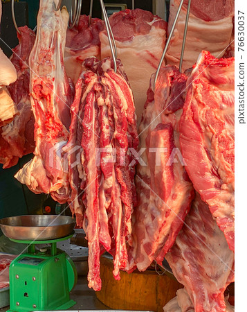Pile of pork ribs hang at local butcher's shop Pile of pork ribs hang at local butcher's shop 76630037