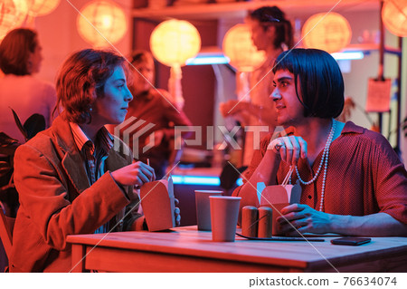 Woman talking to her gay friend 76634074