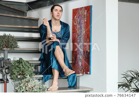 Transgender smoking a cigarette 76634147