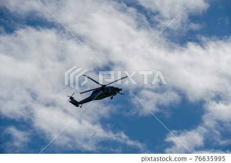 Sheriff Helicopter Hovering on a Beautiful Sky Background 76635995