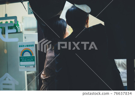 Men and women in their 50s eating out on their way home from work 76637834