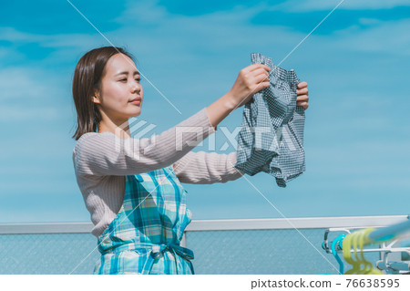 Housewife washing her husband's pants 76638595