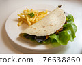 pork carnitas street tacos in yellow corn tortilla with avocado, onion, cilantro and cabbage 76638860