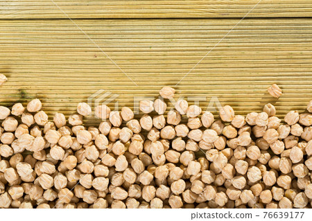 Uncooked chickpea on wooden surface Uncooked chickpea on wooden surface 76639177