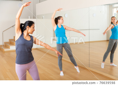 Group of smiling women training sport dance Group of smiling women training sport dance 76639598