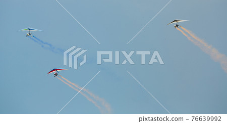 Ultralight trikes performing in sky on air show Ultralight trikes performing in sky on air show 76639992
