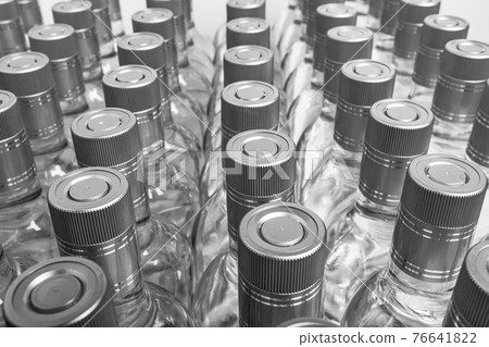 Multitude of pure alcohol bottles not labeled.  76641822