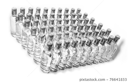 Multitude of pure alcohol bottles not labeled. Bottles of Home Alcoholic Beverages Isolated On White. Small liquor production based on distillation. Bottles empty full  placed in a row. 76641833