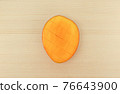 Apple mango cut with a kitchen knife 76643900