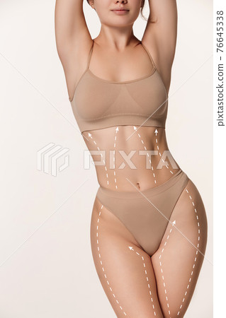 Beautiful slim tanned wonan in underwear isolated over white background. Beautiful slim tanned wonan in underwear isolated over white background. 76645338