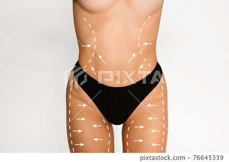 Cropped slim female body in black underwear isolated over white background. Cropped slim female body in black underwear isolated over white background. 76645339