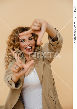 Sexy Caucasian girl with wavy hair posing on the 76645718