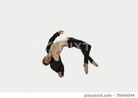 Man in casual style clothes jumping and dancing isolated on white background. Art, motion, action, flexibility, inspiration concept. Flexible caucasian ballet dancer. Man in casual style clothes jumping and dancing isolated on white background. Art, motion, action, flexibility, inspiration concept. Flexible caucasian ballet dancer. 76646044