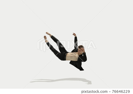 Man in casual style clothes jumping and dancing isolated on white background. Art, motion, action, flexibility, inspiration concept. Flexible caucasian ballet dancer. 76646229