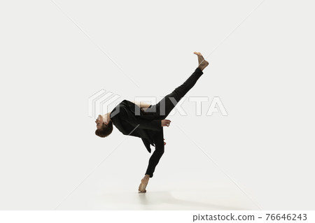 Man in casual style clothes jumping and dancing isolated on white background. Art, motion, action, flexibility, inspiration concept. Flexible caucasian ballet dancer. Man in casual style clothes jumping and dancing isolated on white background. Art, motion, action, flexibility, inspiration concept. Flexible caucasian ballet dancer. 76646243