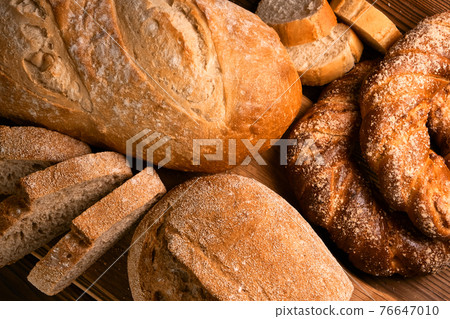 Different kinds of fresh bread as background 76647010