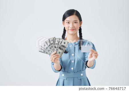 Female employee invest money, make good purchase or deposit, show cash dollars and credit card smile satisfied Female employee invest money, make good purchase or deposit, show cash dollars and credit card smile satisfied 76648717