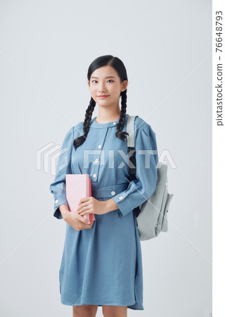 Young Asian student isolated on white background. 76648793