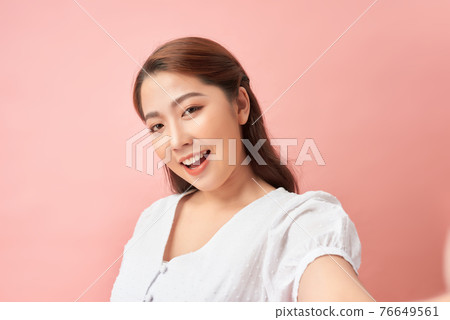 Image of young happy redhead woman isolated over pink wall background make selfie looking camera. Image of young happy redhead woman isolated over pink wall background make selfie looking camera. 76649561