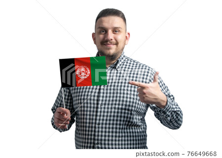 White guy holding a flag of Afghanistan and points the finger of the other hand at the flag isolated on a white background 76649668