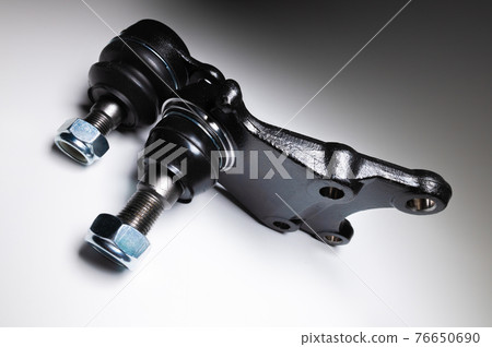 A set of two ball joints of the front suspension of a passenger car on a gray background. Service and new parts A set of two ball joints of the front suspension of a passenger car on a gray background. Service and new parts 76650690