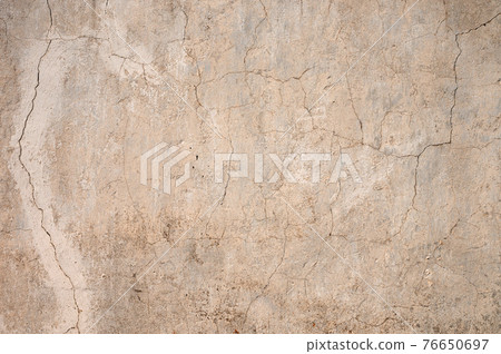 Grunge gray background of cracked peeling walls with peeled putty in beige tones. Grunge gray background of cracked peeling walls with peeled putty in beige tones. 76650697