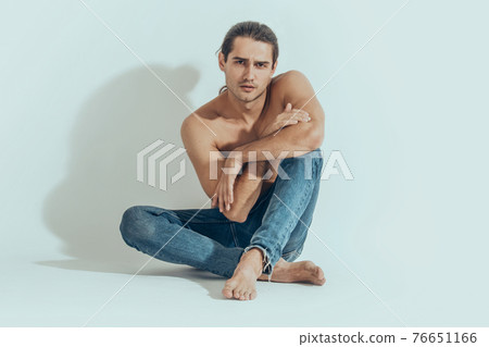 Muscle strong beautiful stripped male model in denim jeans on white isolated font background with shadow Muscle strong beautiful stripped male model in denim jeans on white isolated font background with shadow 76651166